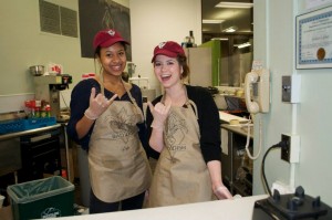 Employees Elizabeth Eckley and Mariam Dembele dish out vegetarian fare at Rad Dish Café’s grand opening in February 2015. (Photo by Allie Guerin)