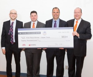 DevelapMe’s Cliff Tironi, Michael Rivera, and Tony Petrucci, from left to right, accept the Upper Track first-place ceremonial check from Alex Wolfington, whose family sponsored more than $120,000 in Be Your Own Boss Bowl prizes. DevelapMe also won BYOBB’s Bernard and Murray Spain Grand Prize, totaling $40,000. (Photo: Lou Caltabiano)