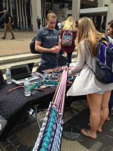 A representative from Into The Nations, which writes business plans for artisans in developing countries, speaks at the non-profit’s table during the What IF innovation festival.
