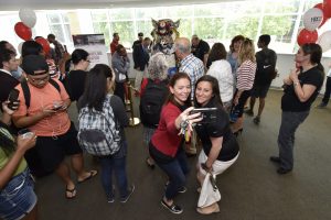 Students take selfie with the statue. Jim Roese Photography