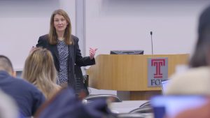 Profesor Gordon in classroom at podium