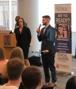 Chapter President Jennifer Serafino, left, and Vice President Patrick Gilbert, right, welcome the crowd, standing in fron of screen with microphone.
