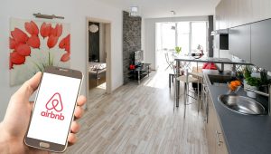 hand holding phone with Air B&B app