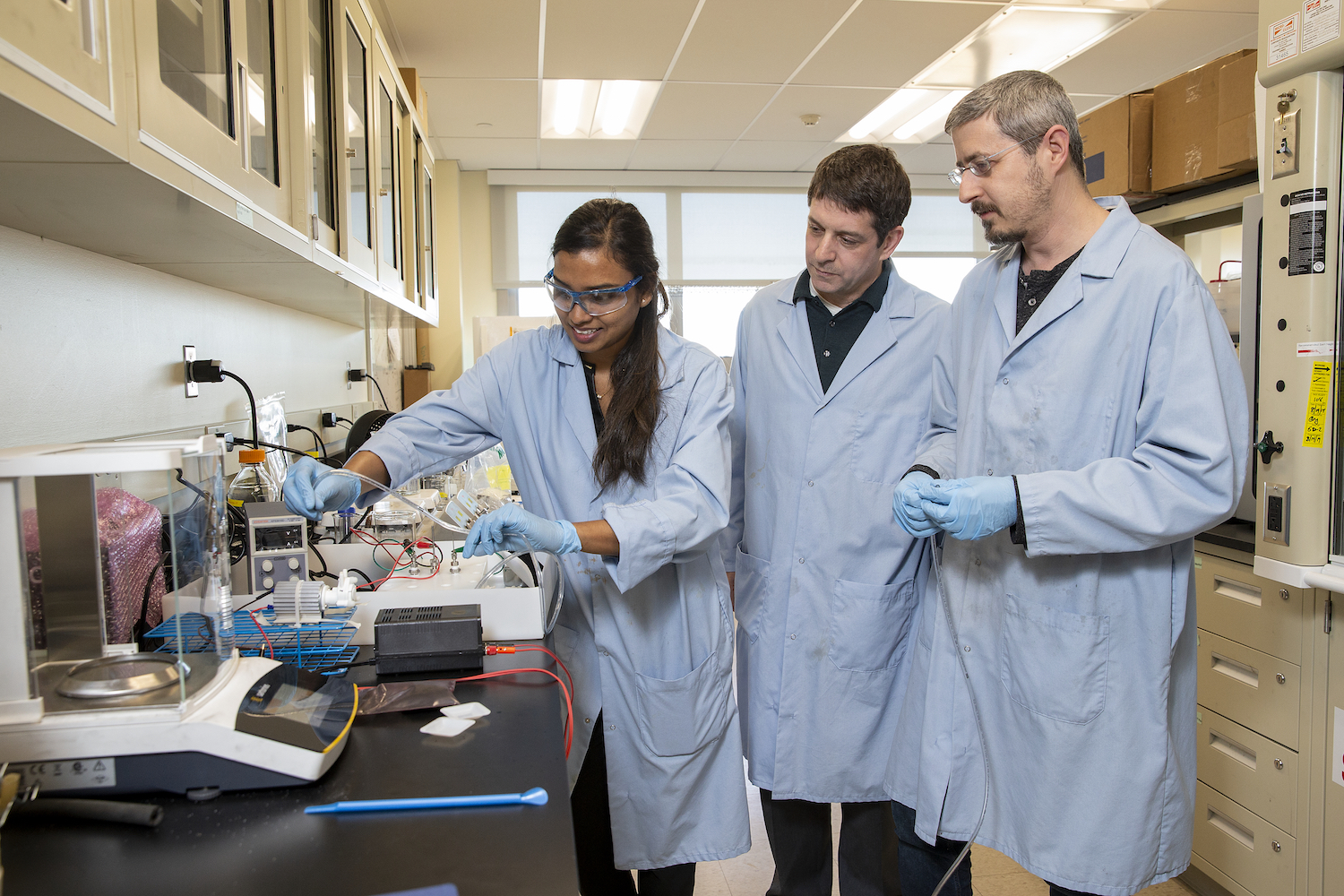 Professors and student in the lab