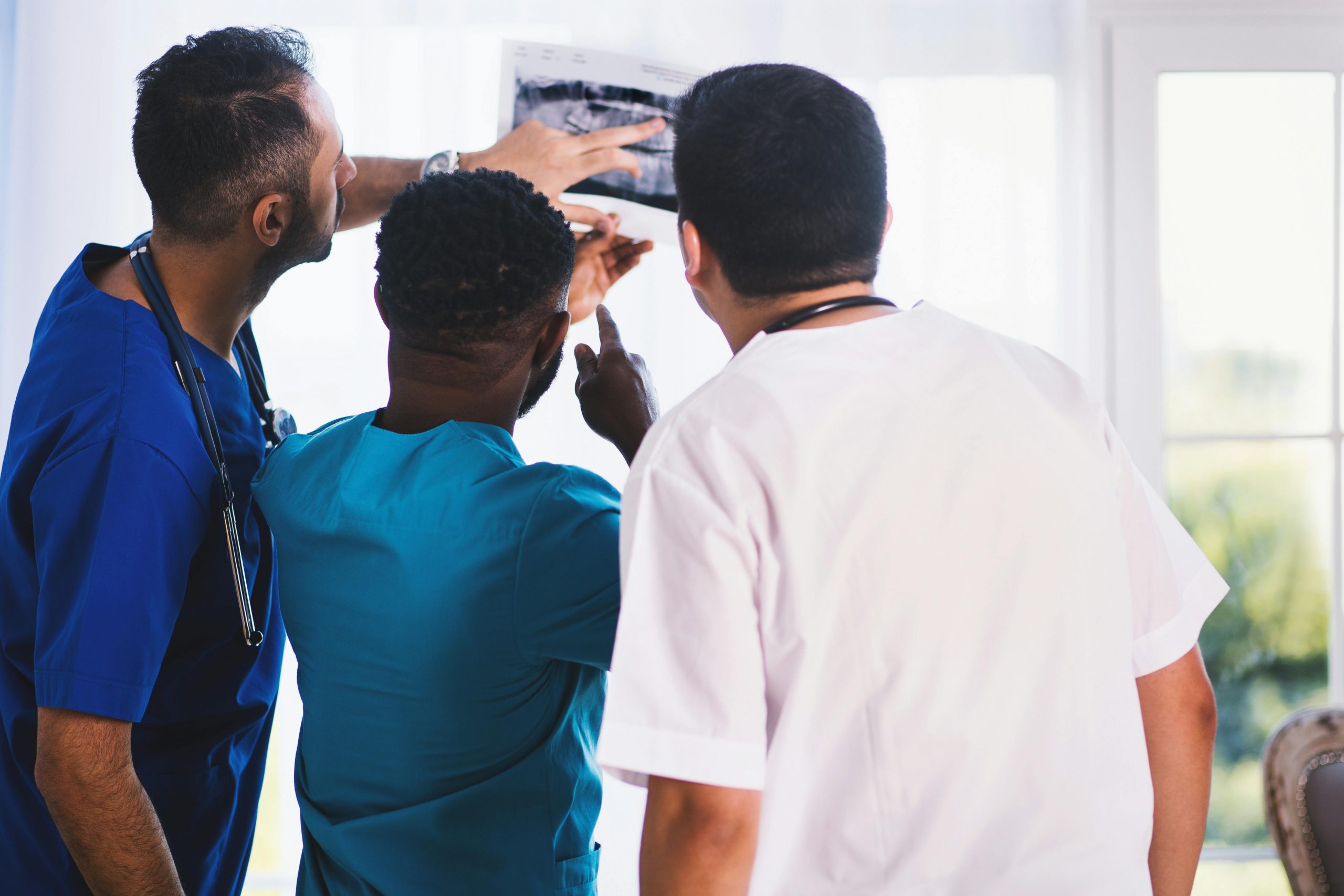 Three doctors looking at an Xray