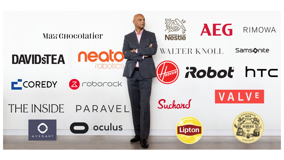 Joydeep Srivastava stands in front of a wall displaying company logos.