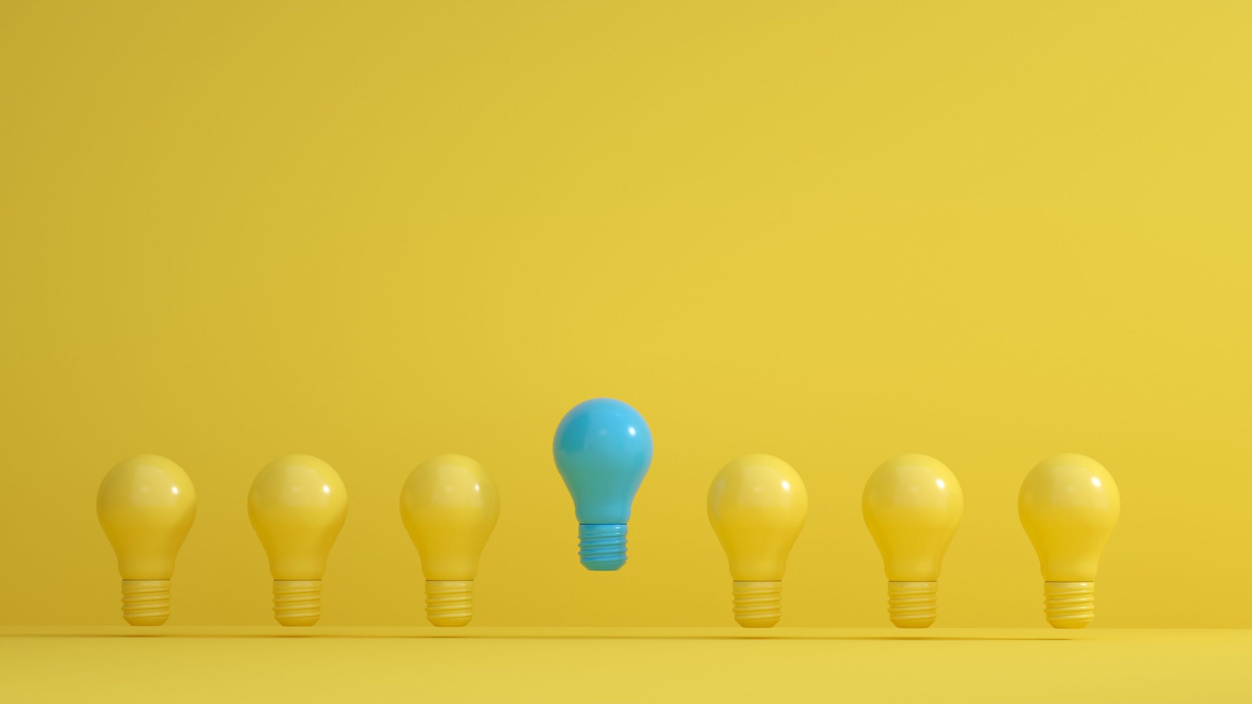 A line of yellow light bulbs interrupted by a blue light bulb