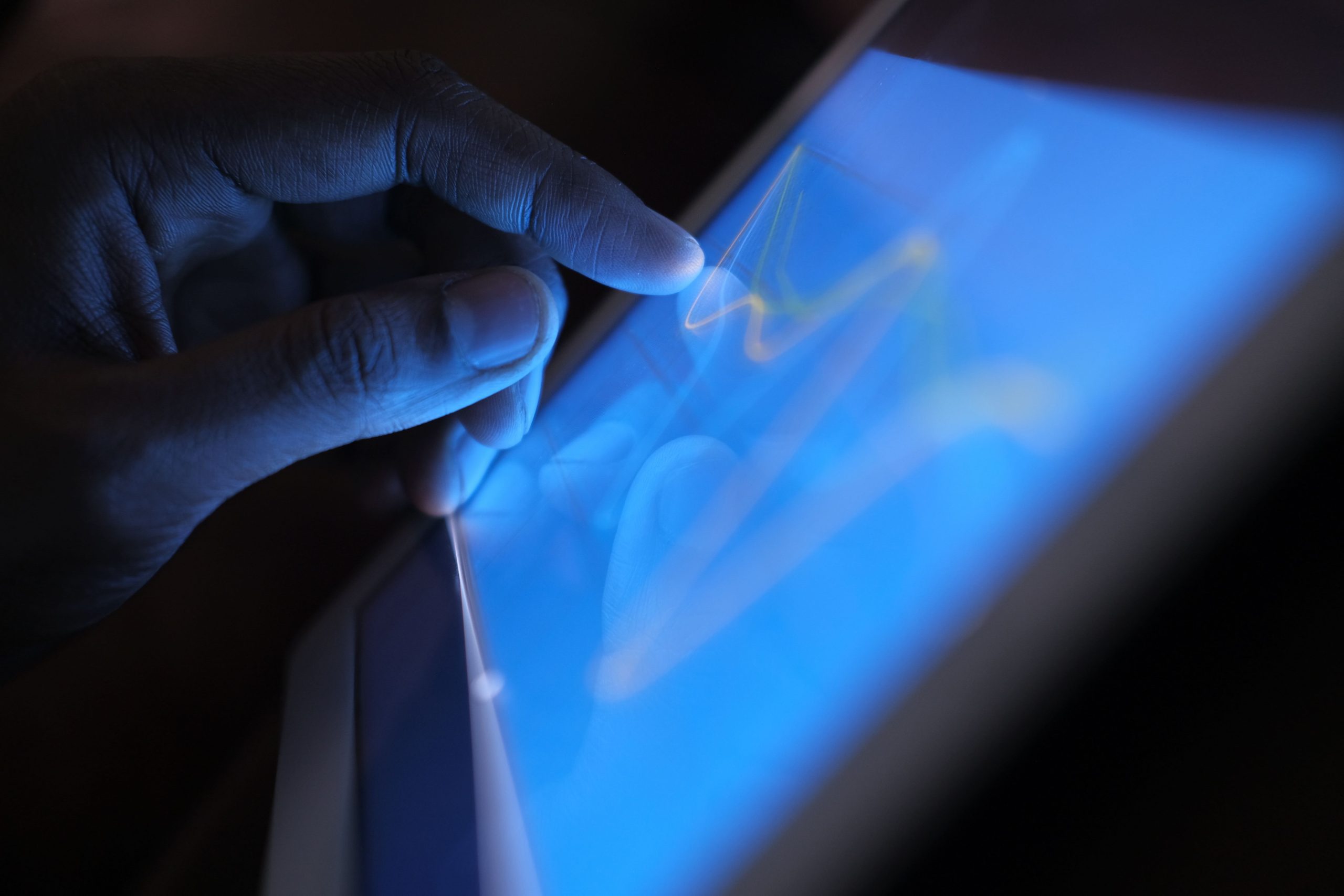 A hand interacting with a tablet screen.